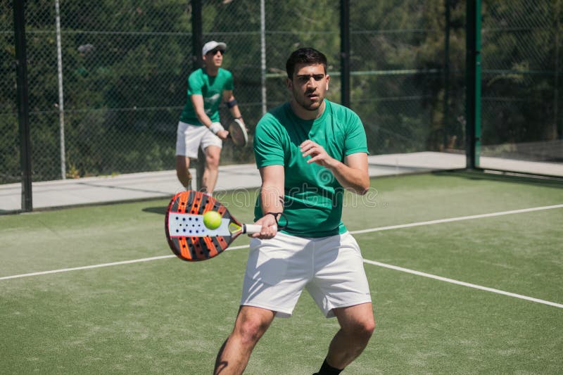 Padel players compete on court